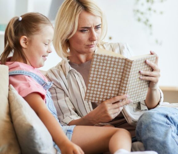 woman-reading-a-book-to-girl-682x1024